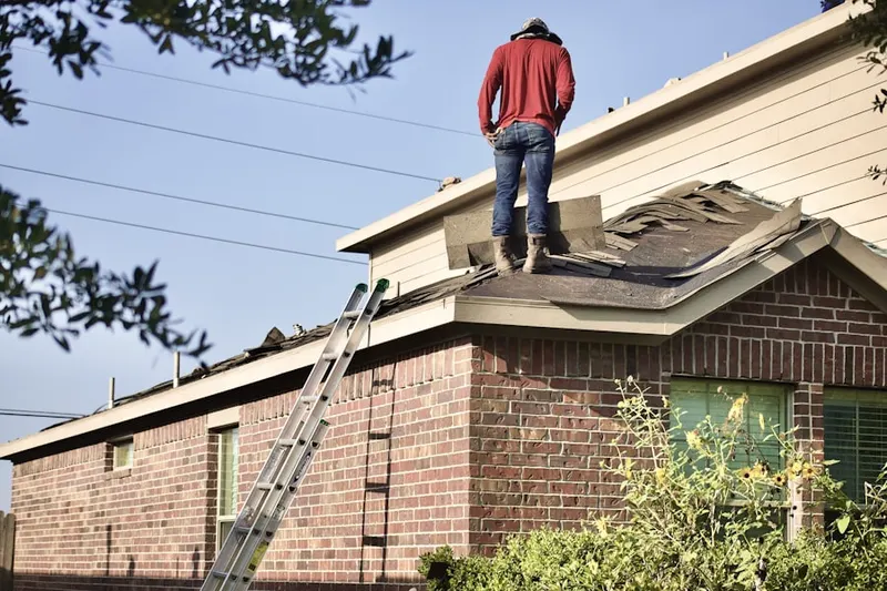 Professional roofer working on a residential roof in Hilton